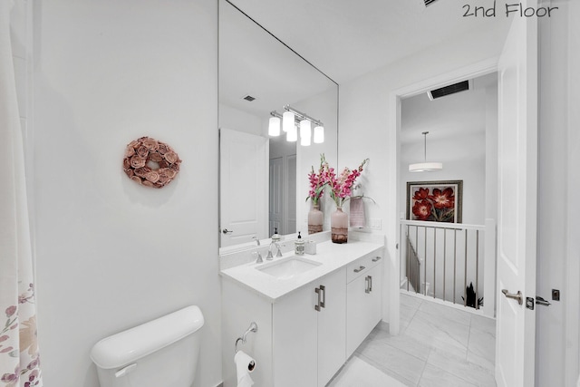 bathroom featuring visible vents, marble finish floor, vanity, and toilet