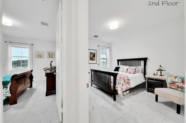 bedroom featuring marble finish floor and visible vents