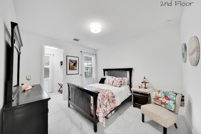 bedroom with visible vents and baseboards