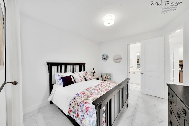 bedroom featuring ensuite bath, marble finish floor, visible vents, and baseboards