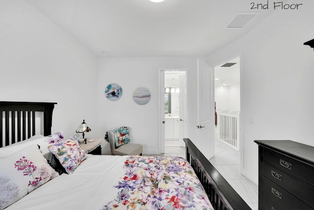 bedroom with marble finish floor, baseboards, visible vents, and ensuite bathroom