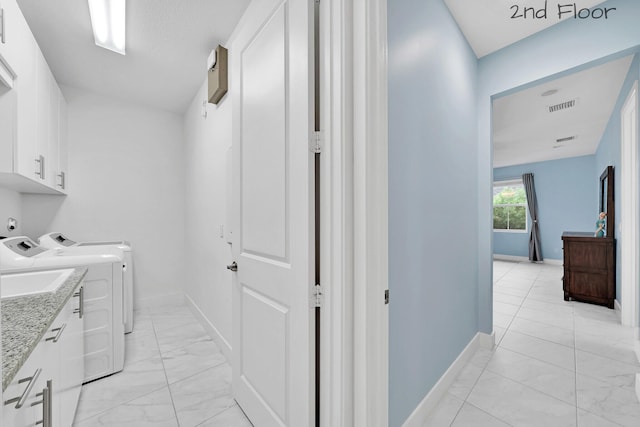 washroom featuring marble finish floor, cabinet space, visible vents, independent washer and dryer, and baseboards