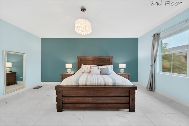 bedroom with marble finish floor, baseboards, and a notable chandelier