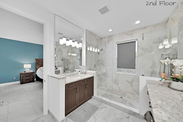 ensuite bathroom with marble finish floor, vanity, a marble finish shower, and visible vents