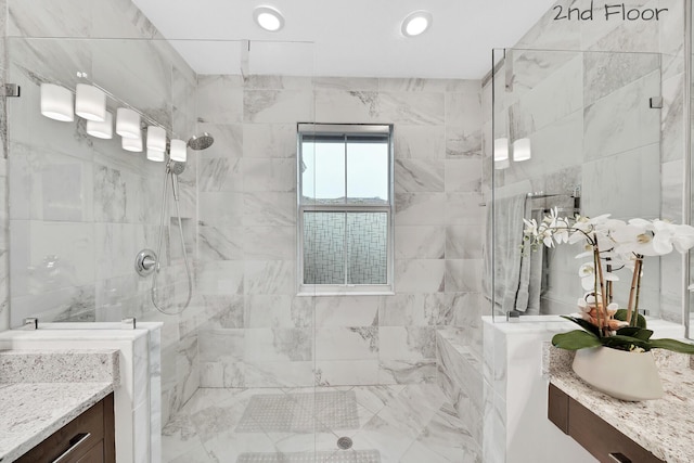 bathroom featuring recessed lighting, vanity, and walk in shower