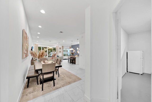 dining area featuring baseboards and recessed lighting