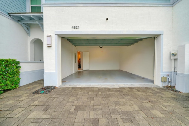 garage featuring decorative driveway