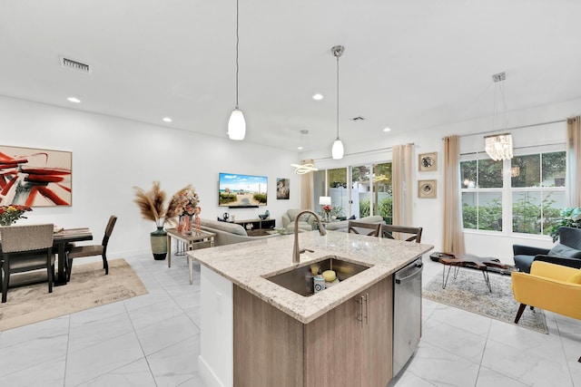 kitchen featuring a sink, visible vents, open floor plan, dishwasher, and pendant lighting