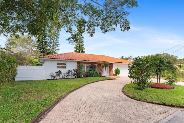 view of front facade with a garage and a front yard