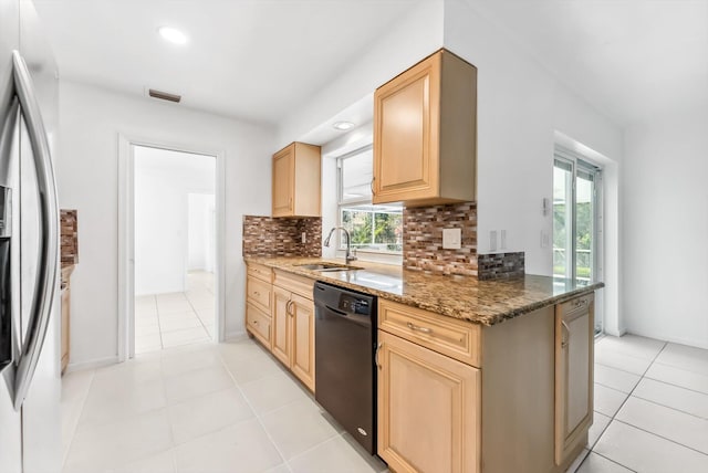 kitchen with stainless steel refrigerator with ice dispenser, black dishwasher, light brown cabinetry, dark stone counters, and sink