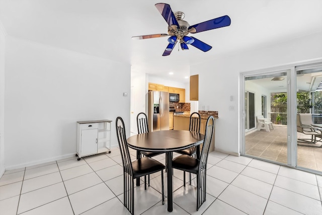 tiled dining area featuring ceiling fan