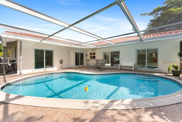 view of pool with a lanai and a patio