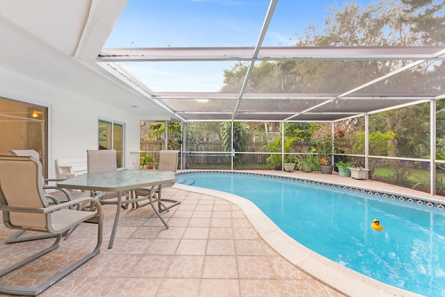 view of pool featuring glass enclosure and a patio