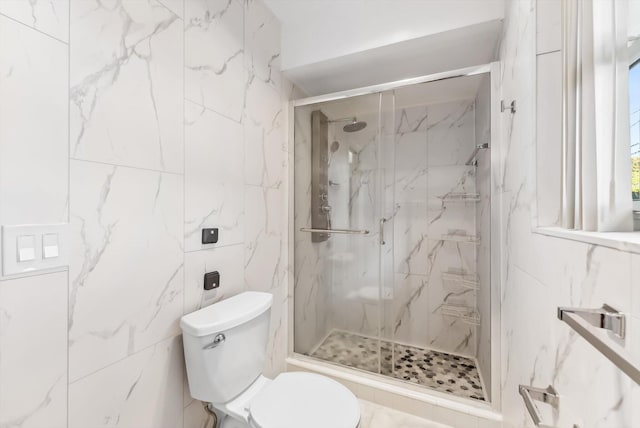 bathroom featuring tile walls, an enclosed shower, and toilet