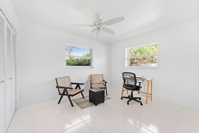 home office featuring ceiling fan, light tile patterned floors, and plenty of natural light