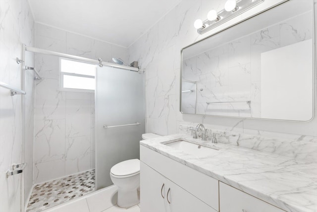 bathroom featuring toilet, vanity, and a tile shower