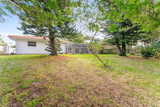 view of yard featuring glass enclosure