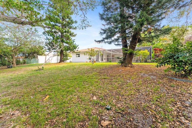 view of yard featuring glass enclosure