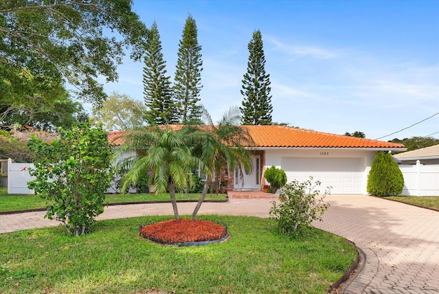 view of front of house with a garage and a front yard