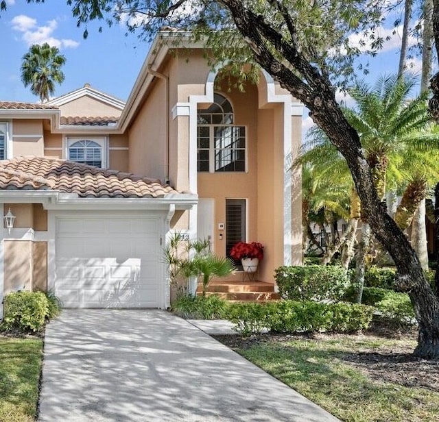 mediterranean / spanish house with a garage