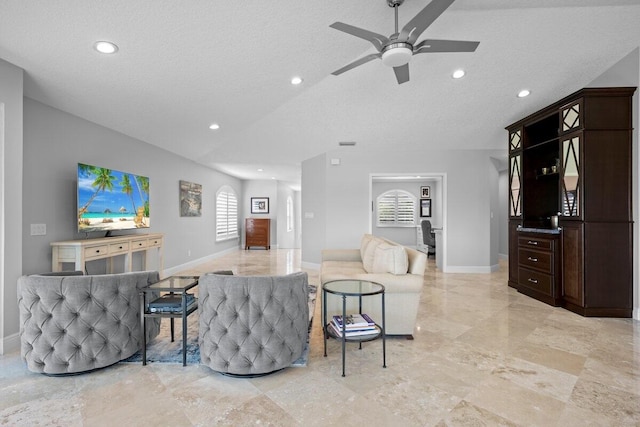 living room featuring a textured ceiling and ceiling fan