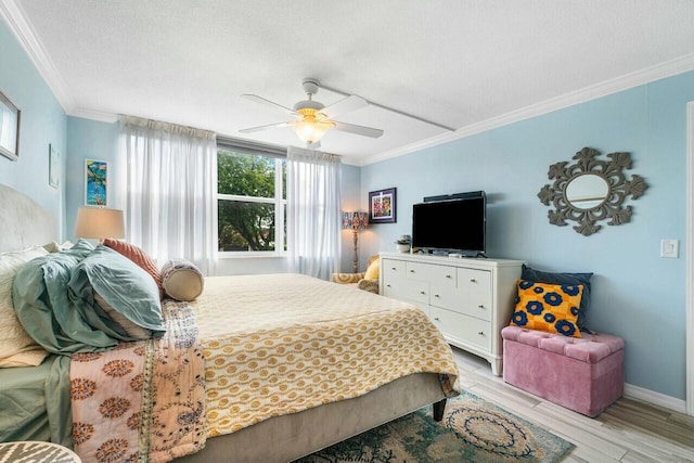 bedroom with ceiling fan, light hardwood / wood-style floors, a textured ceiling, and ornamental molding