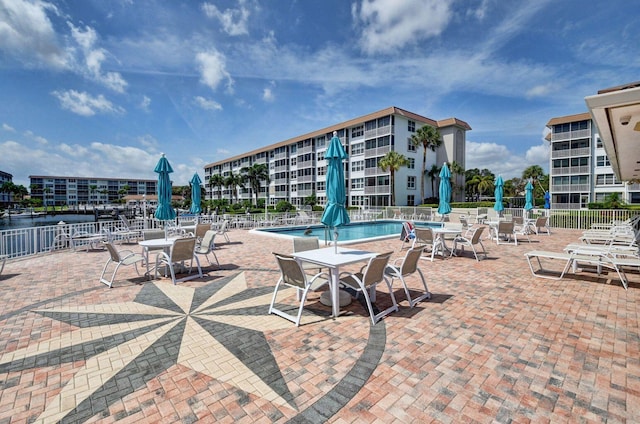 view of patio / terrace with a community pool and a water view