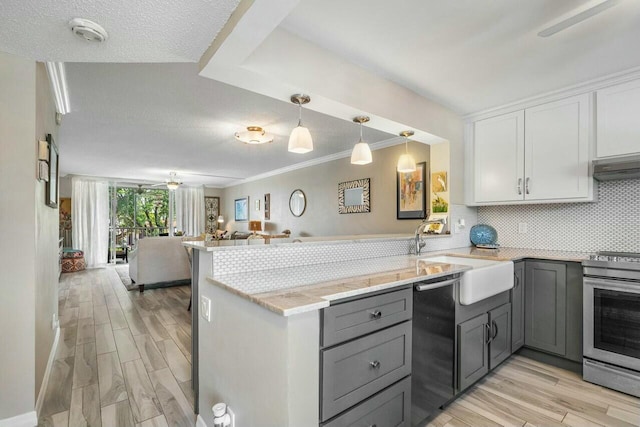 kitchen featuring black dishwasher, kitchen peninsula, stainless steel range with electric cooktop, and white cabinetry