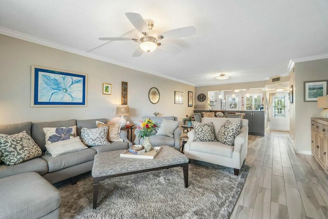 living room with ceiling fan, crown molding, a textured ceiling, and hardwood / wood-style floors