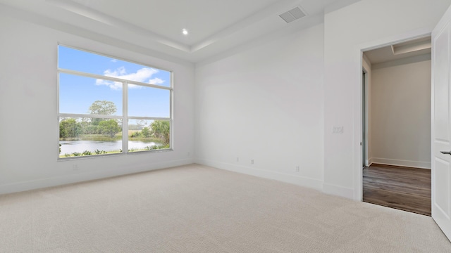 205 SE Via Sangro, Port Saint Lucie, FL 34952 - carpeted spare room featuring baseboards, a tray ceiling, and recessed lighting