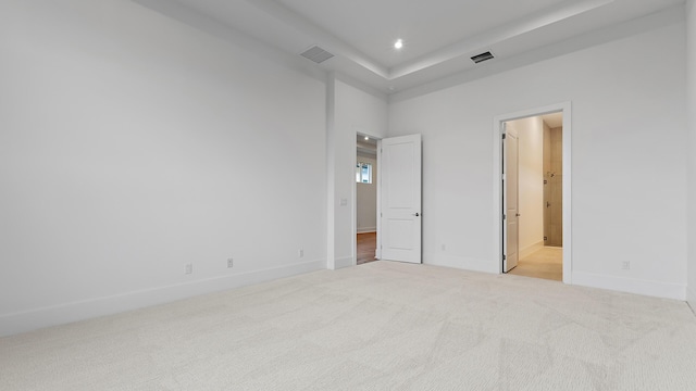 205 SE Via Sangro, Port Saint Lucie, FL 34952 - unfurnished bedroom with light colored carpet, baseboards, recessed lighting, and ensuite bath