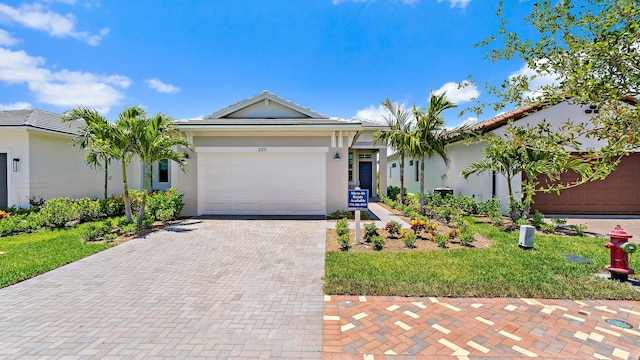205 SE Via Sangro, Port Saint Lucie, FL 34952 - single story home featuring decorative driveway, stucco siding, and a garage