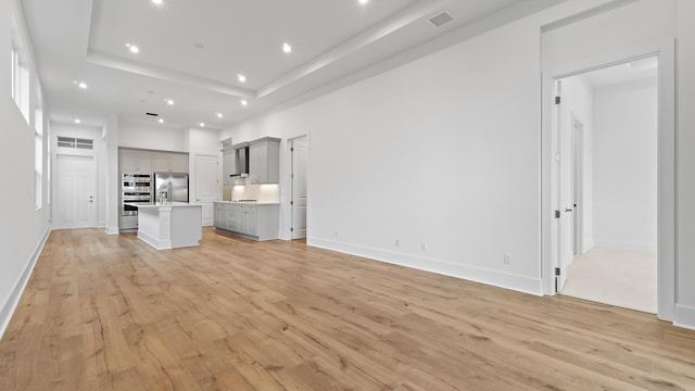 205 SE Via Sangro, Port Saint Lucie, FL 34952 - unfurnished living room featuring recessed lighting, light wood finished floors, and baseboards
