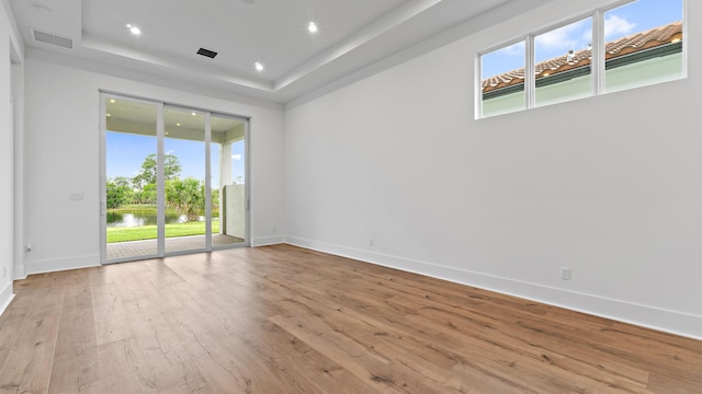 205 SE Via Sangro, Port Saint Lucie, FL 34952 - unfurnished room featuring plenty of natural light, wood-type flooring, baseboards, a raised ceiling, and recessed lighting