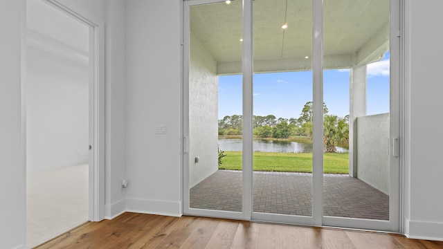 205 SE Via Sangro, Port Saint Lucie, FL 34952 - doorway featuring a water view and wood finished floors