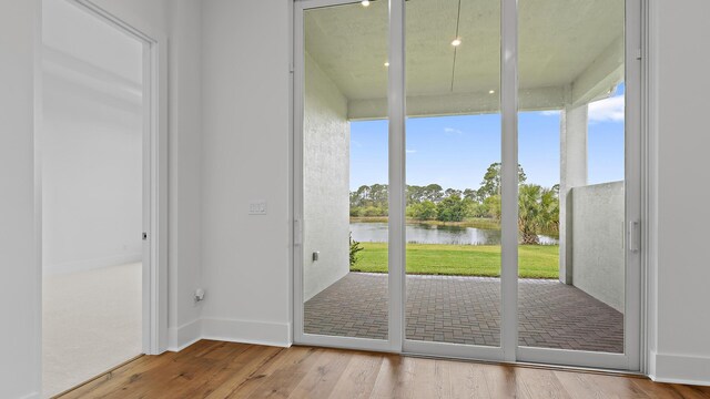 205 SE Via Sangro, Port Saint Lucie, FL 34952 - doorway to outside featuring a water view and wood finished floors