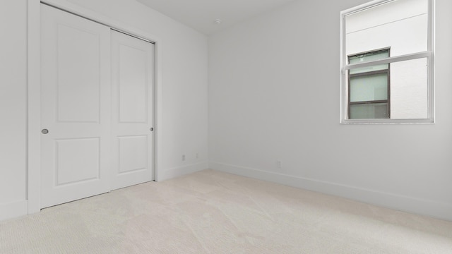 205 SE Via Sangro, Port Saint Lucie, FL 34952 - unfurnished bedroom featuring carpet, a closet, and baseboards