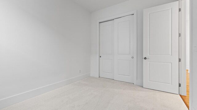 205 SE Via Sangro, Port Saint Lucie, FL 34952 - unfurnished bedroom with a closet, light colored carpet, and baseboards