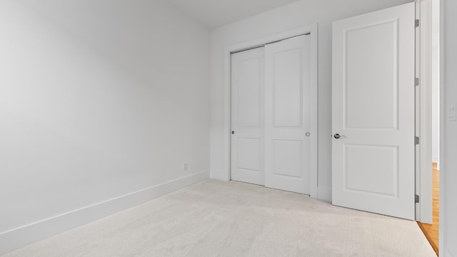 205 SE Via Sangro, Port Saint Lucie, FL 34952 - unfurnished bedroom featuring light carpet, a closet, and baseboards
