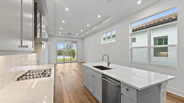 205 SE Via Sangro, Port Saint Lucie, FL 34952 - kitchen with a sink, appliances with stainless steel finishes, light countertops, light wood-style floors, and recessed lighting