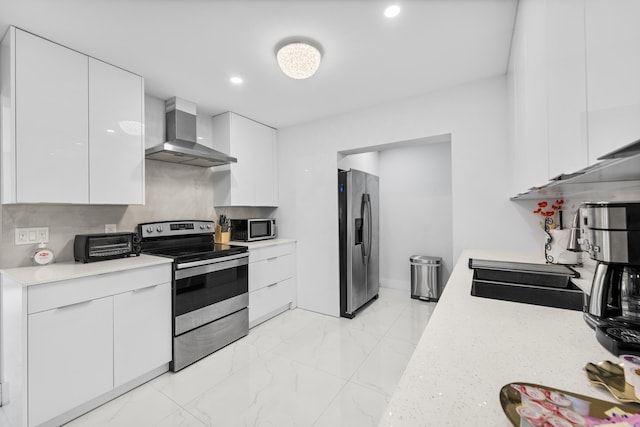 kitchen with wall chimney range hood, sink, appliances with stainless steel finishes, white cabinets, and decorative backsplash