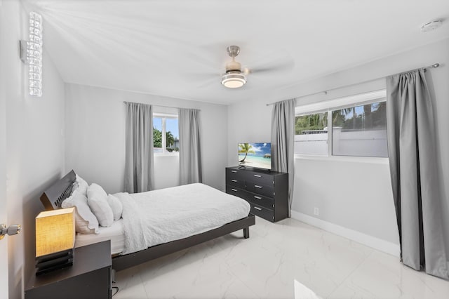 bedroom with multiple windows and ceiling fan