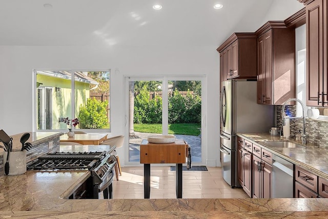 kitchen with stainless steel appliances, sink, and light tile patterned floors