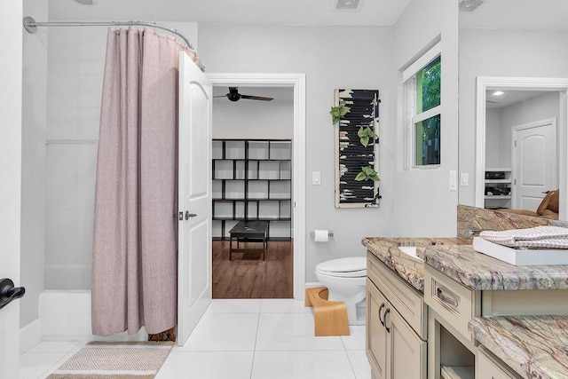 full bathroom with shower / bath combination with curtain, tile patterned floors, toilet, and vanity