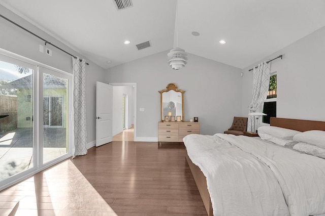 bedroom featuring multiple windows, access to exterior, lofted ceiling, and dark hardwood / wood-style floors