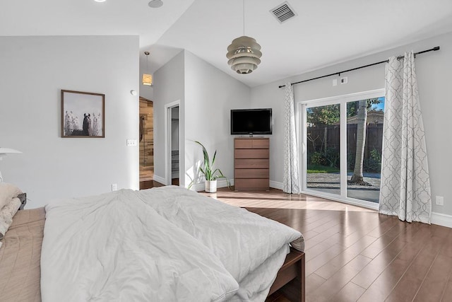 bedroom with lofted ceiling, wood-type flooring, and access to outside