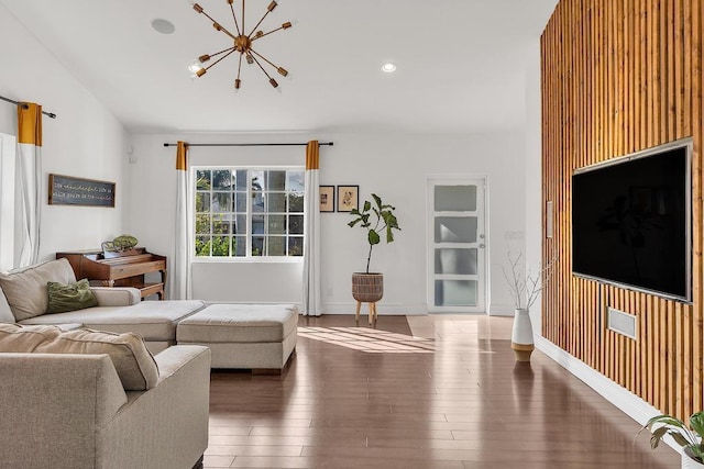 living room featuring a notable chandelier and dark wood-type flooring