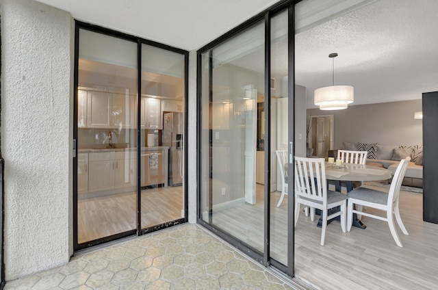 interior space with sink, floor to ceiling windows, and a textured ceiling