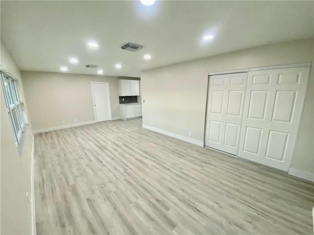 basement featuring light hardwood / wood-style floors