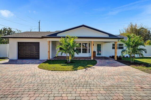 view of front facade featuring a front lawn and a garage